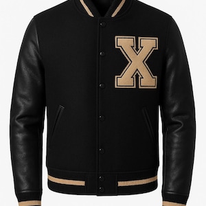 May include: Black varsity jacket with tan leather sleeves and a large tan letter "X" patch on the chest. The jacket has a ribbed collar, cuffs, and hem with tan stripes. It features a button-up front and two front pockets.