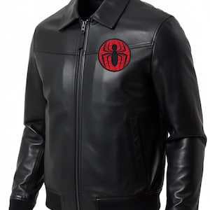 May include: Black leather jacket with a zip-up front, collar, and a red and black spider emblem on the chest. The jacket has black ribbed cuffs and a bomber-style bottom hem.