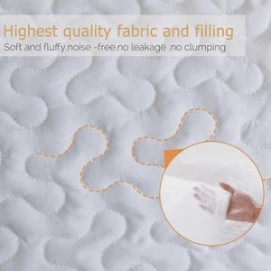 May include: Close-up of a white quilted fabric with a wavy pattern and orange stitching. The text reads "Highest quality fabric and filling" and "Soft and fluffy, noise-free, no leakage, no clumping". A hand holds a sample of the filling.