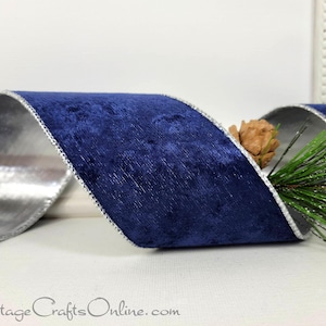 May include: A deep blue velvet ribbon with a metallic silver backing and silver stitched edges, arranged in a loose wave. A small brown pinecone and green pine needles are tucked behind the ribbon. The text CottageCraftsOnline.com is visible.