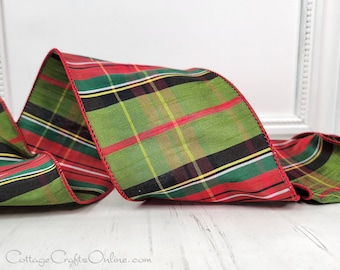 May include: Red, green, black, and white plaid ribbon with a red edge. The ribbon is made of a silky fabric and has a subtle sheen.
