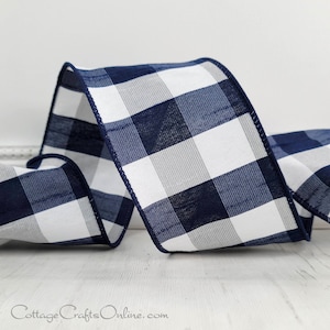 May include: A roll of navy blue and white buffalo plaid ribbon. The ribbon is 2.5 inches wide and has a wired edge.