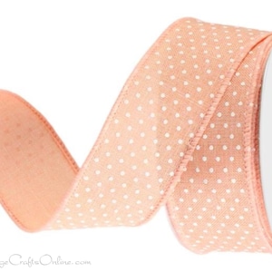 May include: Peach colored ribbon with white polka dots. The ribbon is on a spool and is ready to be used for crafting or decorating.