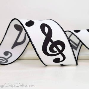 May include: White ribbon with black musical notes printed on it. The ribbon has a black edge.