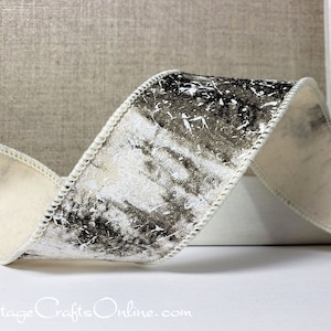 May include: White ribbon with a black and white distressed pattern. The ribbon has a white edge and is folded in a curve.