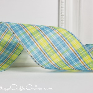 May include: A wide wired ribbon featuring a plaid pattern in shades of light blue, bright yellow, and thin orange stripes. The fabric has a woven texture with a light blue stitched edge. The text CottageCraftsOnline.com is printed at the bottom.