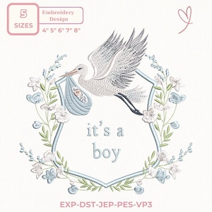 Puede incluir: Diseño de bordado con una cigüeña que lleva un bebé en un fardo azul, rodeado por un marco floral. El texto "it's a boy" está presente. Incluye tamaños de 10 cm, 13 cm, 15 cm, 18 cm y 20 cm.