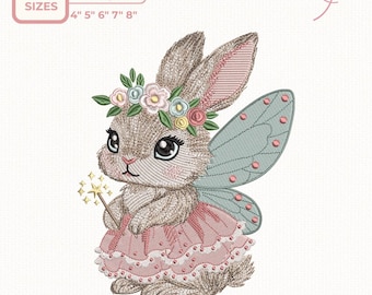 May include: An embroidery design featuring a whimsical bunny fairy. The bunny wears a pink dress, a flower crown, and has blue fairy wings. The design is available in 5 sizes: 4", 5", 6", 7", and 8".