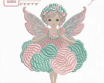May include: An embroidery design of a fairy in pink and teal. The fairy has a floral crown and a dress made of embroidered flowers. Available in 5 sizes: 10.16cm, 12.7cm, 15.24cm, 17.78cm, and 20.32cm. The design includes the text "Embroidery Design".