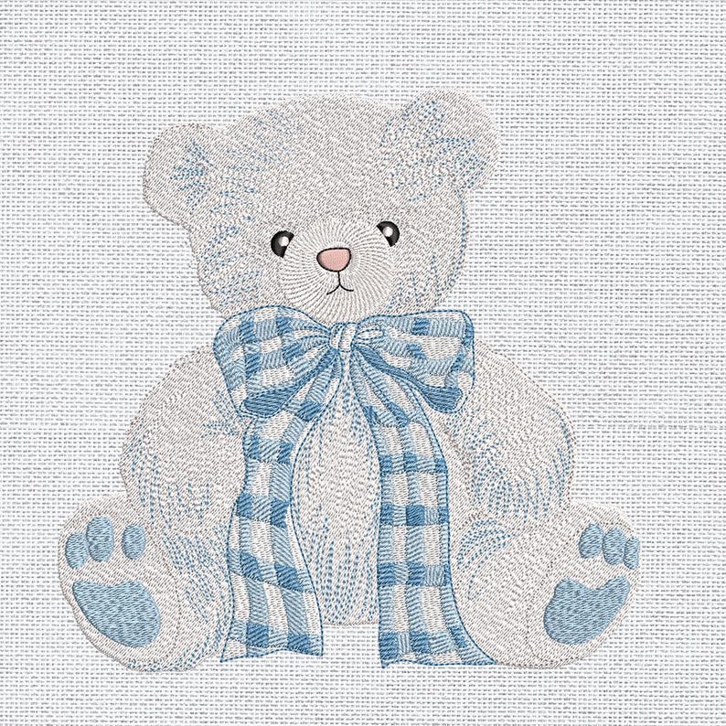 May include: Embroidered teddy bear with a blue and white gingham bow. The bear is light gray with blue accents, including the paws and the bow. The bear has a pink nose and black eyes. The background is a light blue fabric.
