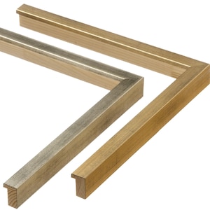 May include: Close-up of two wooden picture frames. One frame has a gold finish, and the other has a silver finish. The frames are angled to show their corner construction and the natural wood grain.