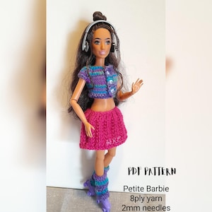 May include: A doll wearing a handmade crochet outfit, including a purple and blue striped top, a pink skirt, and leg warmers. The doll has headphones and roller skates. The text "PDF PATTERN" and other details are visible.