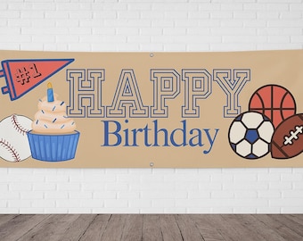 May include: A tan banner with the words "HAPPY Birthday" in blue outlined letters. The banner features a baseball, cupcake, soccer ball, basketball, and football. A pennant with the number "#1" is also included.