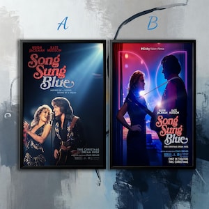 Op de afbeelding: Twee ingelijste filmposters voor "Song Sung Blue" met Hugh Jackman en Kate Hudson. De posters hebben een zwart frame en tonen afbeeldingen van de acteurs, met de filmtitel in een glitterlettertype.