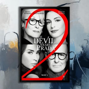 May include: Framed movie poster for "The Devil Wears Prada" featuring Meryl Streep, Anne Hathaway, Emily Blunt, and Stanley Tucci. The title is in bold white letters, with a large red number "2" overlaying the image. The date "MAY 1" is at the bottom.