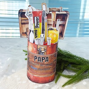 May include: A handmade Father's Day card shaped like a toolbox, featuring tools and the word "PAPA". The card includes a tube of UHU Power glue, a black marker, a pencil, and a measuring tape.