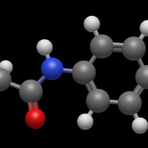 May include: A 3D molecular model of a chemical compound, featuring gray spheres representing carbon atoms, white spheres for hydrogen, red for oxygen, and blue for nitrogen. The structure is set against a black background.