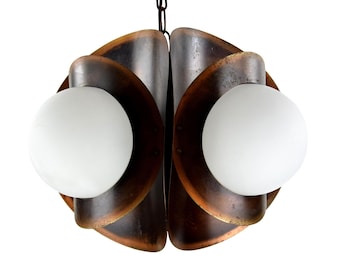 May include: A vintage, mid-century modern chandelier with a distinctive design. The light fitting has curved, copper-toned metal elements around two white globe lights. The chandelier is suspended from a central, bronze-coloured canopy.