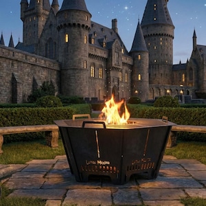 May include: A black metal fire pit with a burning fire, set in a stone patio with benches. The background features a castle with illuminated windows under a twilight sky with a crescent moon and stars.