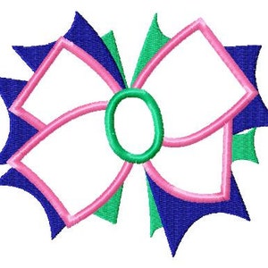 May include: A pink and white bow with blue and green accents. The bow is a stylized design with a center circle.