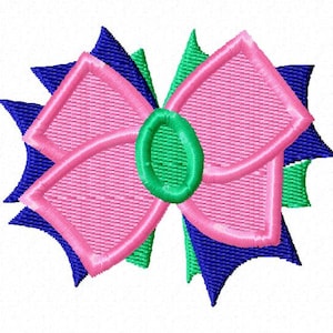 May include: A pink bow with blue and green accents. The bow is made of fabric and has a textured appearance.