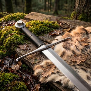 May include: A metal sword with a black leather-wrapped grip and a circular pommel. The crossguard is straight with slightly curved ends. The blade is polished steel, extending from the hilt, resting on a textured wooden surface with moss.