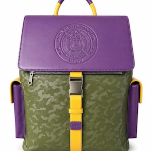May include: A backpack featuring an olive green camouflage pattern, a purple top flap with an embossed Omega Psi Phi Fraternity, Inc. logo, yellow accents, a central yellow strap with a silver buckle, and purple side pockets with yellow trim.