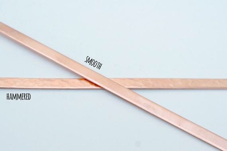 May include: Two pieces of copper metal, one smooth and one hammered, are crossed over each other. The smooth piece is labeled "SMOOTH" and the hammered piece is labeled "HAMMERED".