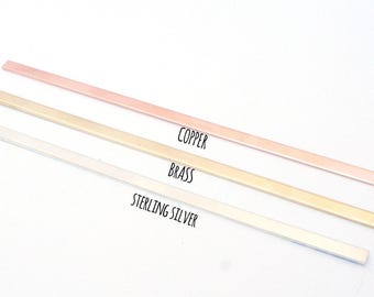 May include: Three thin, flat metal bars arranged diagonally. The top bar is copper, the middle bar is brass, and the bottom bar is sterling silver. The text labels Copper, Brass, and Sterling Silver are printed next to each corresponding metal bar.