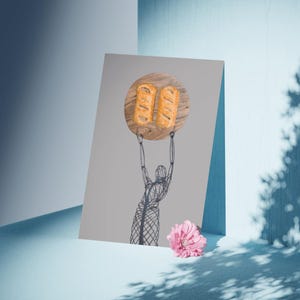 May include: Illustration of a figure holding a wooden plate with two golden-brown pastries. The figure is a wireframe drawing. A pink flower rests on the light blue surface. The background is a light gray and blue.