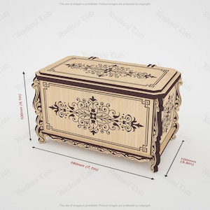 May include: A decorative wooden chest with ornate floral and scrollwork designs. The chest is light brown with dark brown accents and measures 7.1 inches long, 3.9 inches wide, and 4.1 inches high.