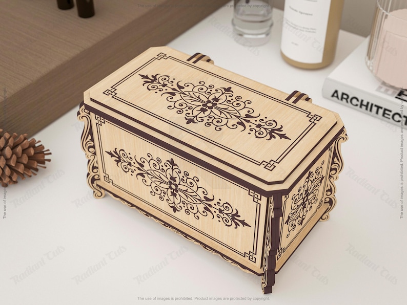 May include: A decorative wooden box with a light brown finish and dark brown accents. The box features intricate floral and geometric patterns on the lid and sides. The box has a rectangular shape with curved edges and a handle.