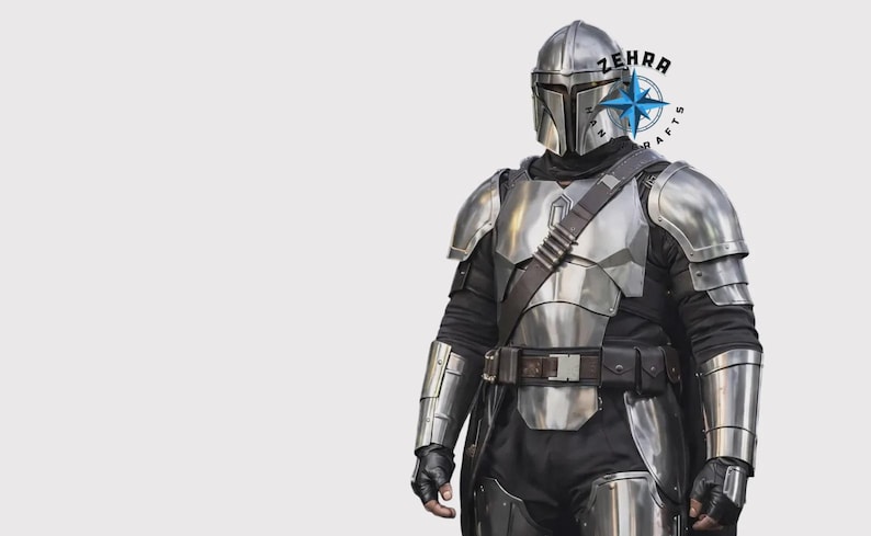 May include: A silver Mandalorian armor set, including a helmet, chest plate, shoulder pads, and arm guards. The armor is worn over a black undersuit with a brown belt and strap. The image includes the text "ZEHRA CRAFTS".