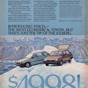 May include: A 1983 Toyota Tercel advertisement featuring a light blue and a tan 3-door hatchback parked on a large iceberg. The text reads: Introducing Tercel—the most economical Toyota. But that's just the tip of the iceberg. Oh what a feeling! Toyota.
