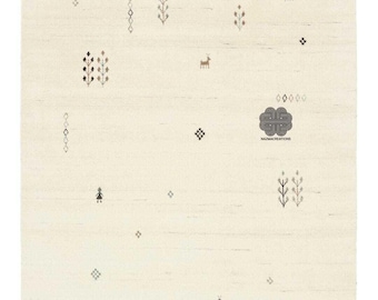 May include: Cream-colored area rug with a minimalist design. The rug features scattered geometric shapes, stylized trees, and deer in shades of gray and brown. The rug has a textured appearance and the text "nazmacreations" is visible.