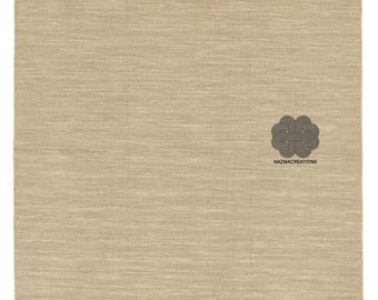 May include: A rectangular beige rug with a textured surface. The rug has a simple design and a logo in the bottom right corner that reads "NAZMACREATIONS". The rug is made of a woven material.