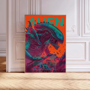 May include: A framed poster featuring the word "ALIEN" in large, teal letters against an orange background. The poster depicts a detailed illustration of an alien creature in shades of teal, purple, and red. Text at the bottom reads "DIRECTED BY RIDLEY SCOTT."