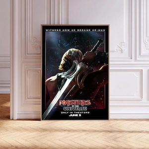 May include: A framed movie poster for "Masters of the Universe." The poster features a dramatic image of He-Man with a sword, with the text "WITNESS HOW HE BECAME HE-MAN" at the top. The movie title and release date are also visible.