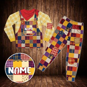 May include: A long-sleeve yellow plaid shirt with a red bandana neckerchief and attached overalls featuring a multi-colored patchwork pattern. The chest pocket displays the text NAME. Matching patchwork pants include a blue star patch.