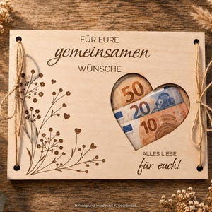 May include: A rectangular light-colored wooden plaque featuring the German text F&Uuml;R EURE gemeinsamen W&Uuml;NSCHE and ALLES LIEBE f&uuml;r euch. It includes a heart-shaped cutout displaying 50, 20, and 10 Euro banknotes, with laser-engraved floral designs.
