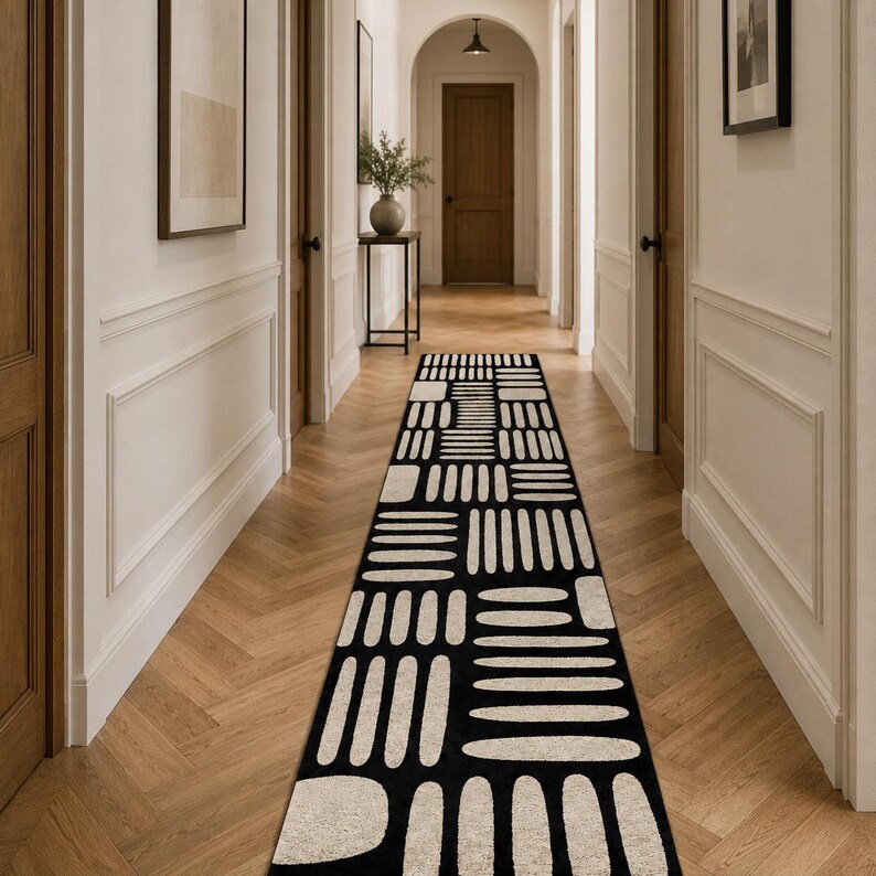 Black & ivory modern geometric hallway runner rug centered in a long luxury corridor, hand tufted wool runner for elegant entryway and contemporary interiors