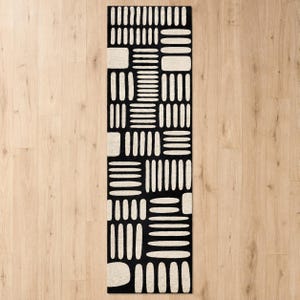 Black & ivory modern geometric hand tufted wool runner rug on light wood floor, abstract hallway runner rug for entryway, kitchen, and contemporary home decor