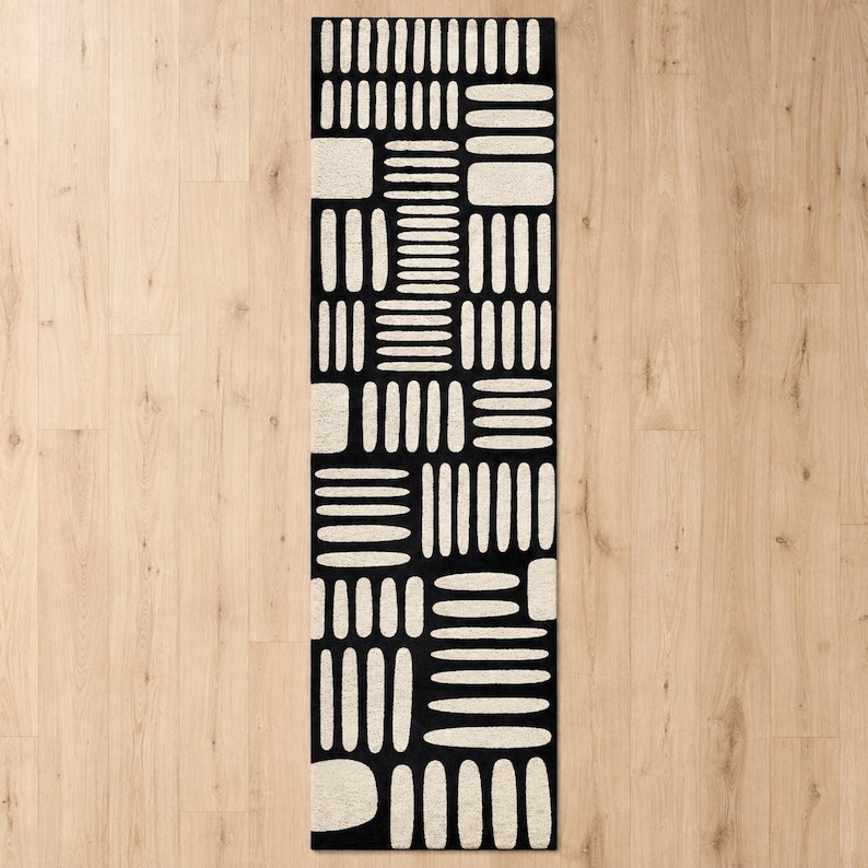 Black & ivory modern geometric hand tufted wool runner rug on light wood floor, abstract hallway runner rug for entryway, kitchen, and contemporary home decor