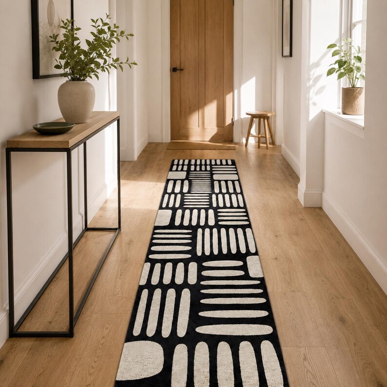 Modern black & ivory hand tufted runner rug in a bright Scandinavian entryway with console table, minimalist hallway carpet for stylish home decor