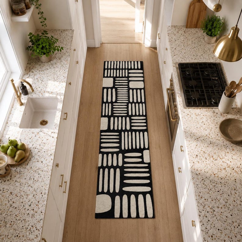 Black & ivory geometric kitchen runner rug between white cabinets, hand tufted modern wool runner for galley kitchen, hallway, and entryway decor
