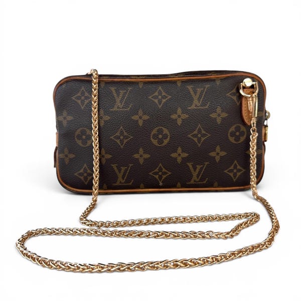 May include: A rectangular brown handbag featuring the iconic Louis Vuitton monogram pattern in dark brown and tan. The bag includes a gold-tone metal chain shoulder strap attached with a lobster clasp, and brown leather trim along the edges.