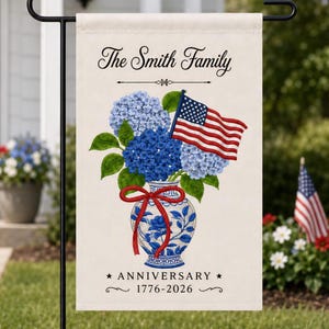 May include: A cream-colored garden flag featuring a blue and white vase filled with blue hydrangeas and an American flag. The text "The Smith Family" is at the top, with "ANNIVERSARY 1776-2026" at the bottom.