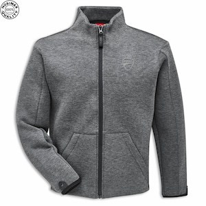 May include: A gray zip-up jacket with a high collar and a small logo on the chest. The jacket has a full-length zipper, two front pockets, and black trim on the cuffs and hem. The jacket is made of a soft, textured material.