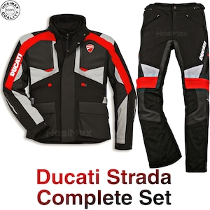 May include: Ducati Strada complete motorcycle jacket and trousers set in black and red. The jacket features red shoulder and arm detailing, with the Ducati logo. The trousers are black with red and grey accents.