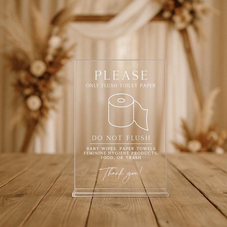 May include: Transparent acrylic sign with white text and a toilet roll graphic. The sign says "PLEASE ONLY FLUSH TOILET PAPER" and "DO NOT FLUSH" with a list of items. The sign includes "Thank you!" at the bottom.